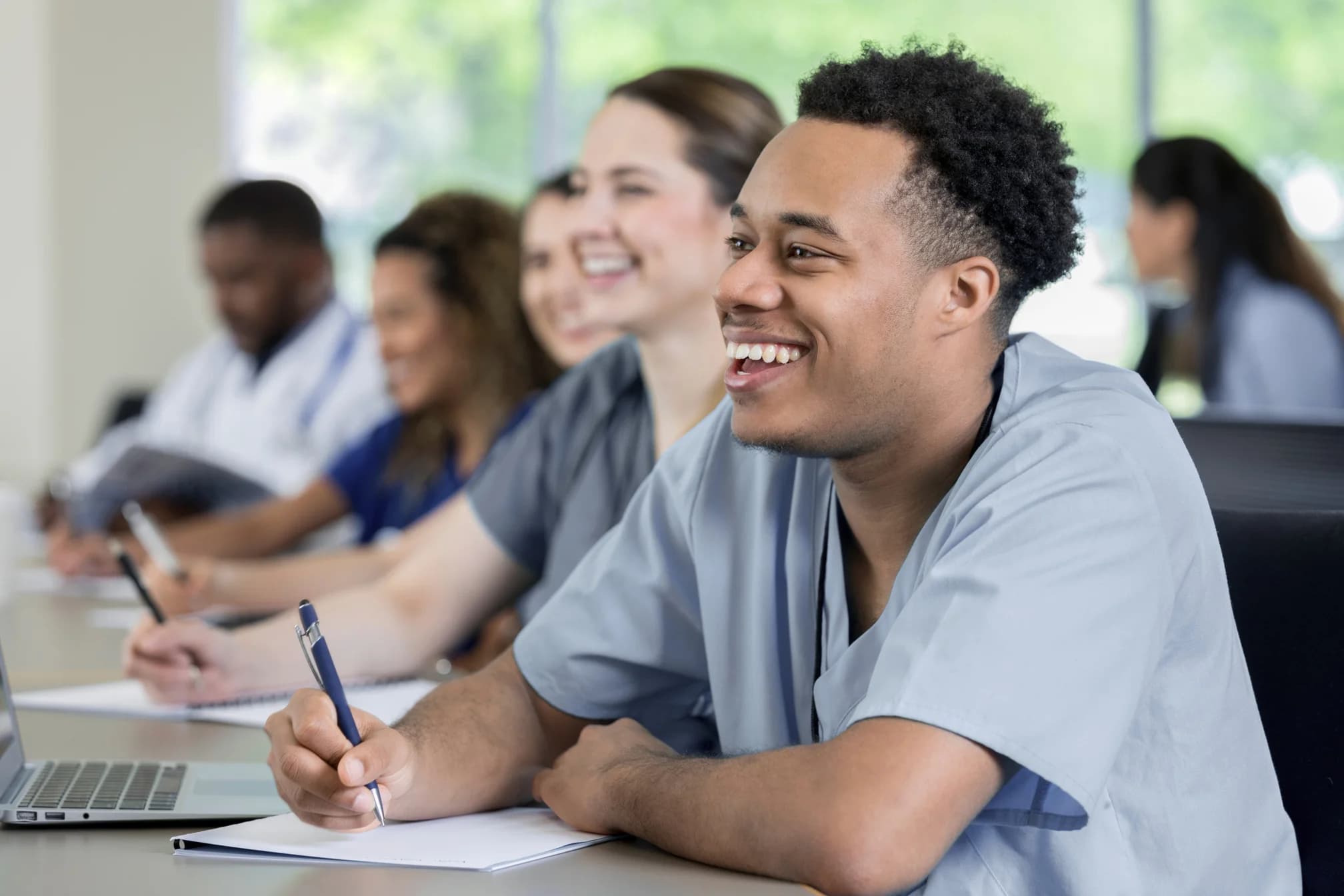 State Career College students in scrubs learning in a classroom